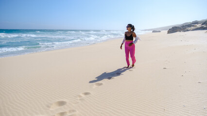 Asian women relaxing on the beach at De Hoop Nature Reserve South Africa Western Cape, the most beautiful beach in South Africa with the white dunes part of the garden route. 