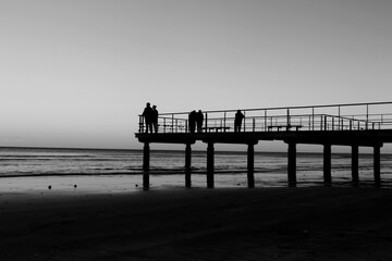 Fototapeta na wymiar People standing on the pier and looking at the sea in Larnaca, Cyprus