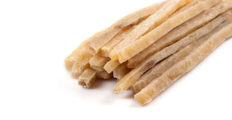 Close-up of dried salted tuna stripes background. Beer snacks, restaurant menu, salty seafood