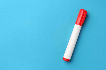Bright red marker on light blue background, top view. Space for text