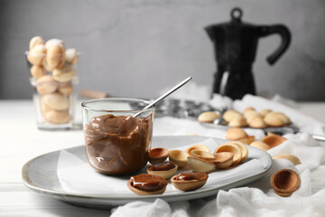 Delicious walnut shaped cookies with condensed milk on table