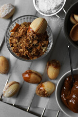 Fototapeta premium Delicious walnut shaped cookies with condensed milk on grey table, flat lay