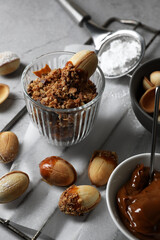 Delicious walnut shaped cookies with condensed milk on grey table, closeup
