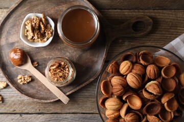 Making walnut shaped cookies. Cooked dough, caramelized condensed milk and nuts on wooden table, flat lay