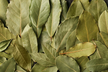 Aromatic bay leaves as background, top view