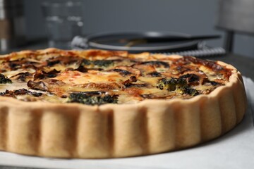 Delicious quiche with mushrooms on white table, closeup
