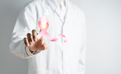 Doctor holding virtual pink ribbon cancer, Breast cancer awareness and health care medical check-up...