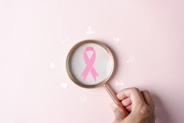 Magnifying glass with pink ribbon cancer inside, Breast cancer awareness and health care medical...