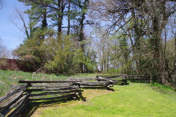 Fototapeta na wymiar A line of Traditional Wooden Split-Rail fencing at the edge of woodland, Virginia, USA. 
