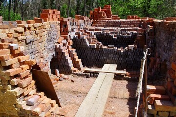 A pile of hand fired red bricks build up to make a traditional pottery kiln. Virginia, USA. 