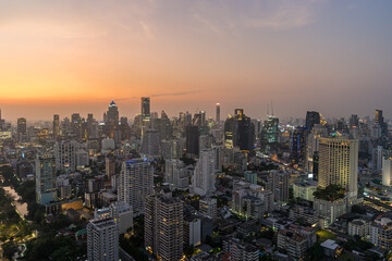 Fototapeta na wymiar Scenery cityscape of Illuminated Bangkok city metropolis in twilight. Panoramic skyline urban panorama of modern city on dusk. High-angle view