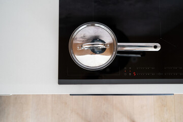 cooking at home with contemporary electrical hob