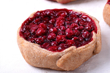 Kalitka pie, Karelian pasty, with cowberry on white table