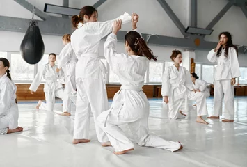 Deurstickers Teenage girls fighting at aikido training in martial arts school © Nomad_Soul
