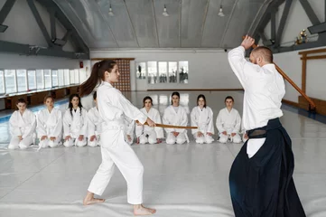 Fotobehang Kendo master and sudent fighting with wooden sword during martial arts class © Nomad_Soul