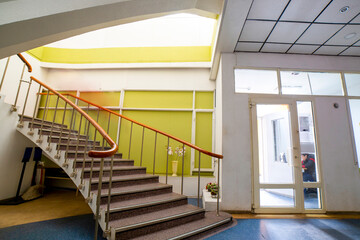 A fragment of the interior with a staircase to the second floor in a residential building