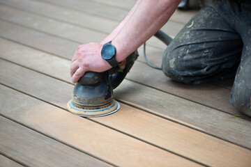 Sanding process of wooden terrace floors. Sanding machine remove imperfections.