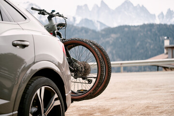 The car carries bikes. A vehicle traveling along a motorway with several bikes held on the rear...