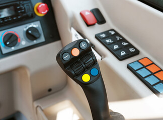 Control panel and Joystick of steering of construction loader machine closeup.