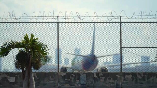 Protective barbed wire fence surrounding Miami airport runway as security measure against tresspassing