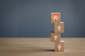 Wooden block at red question mark on table, concept of problem analysis, creativity analytical thinking process Or find out the cause that occurs during the work process