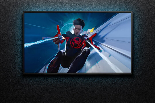 TV screen playing Spider-Man Across the Spider-Verse trailer or movie. TV on black textured wall. Astana, Kazakhstan - May 15, 2023.