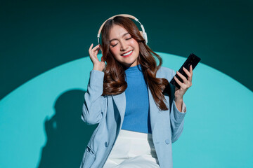 carefree smiling peaceful moment Asian female woman listen music playlist smartphone wireless...