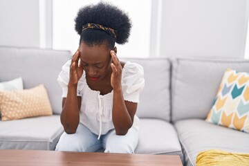 Fototapeta na wymiar African american woman stressed sitting on sofa at home