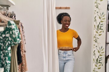 African american woman customer wearing t shirt at clothing store