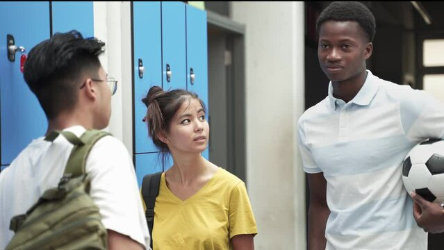 Students chatting in a college or high school corridor. Teenage Friends at school. 