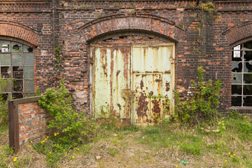 Fototapeta na wymiar The Imperial Shipyard Trail - high gate of abandoned destroyed hall. Gdansk, Poland.