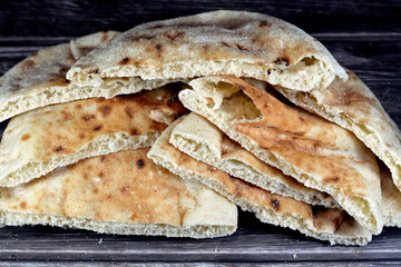 Traditional Egyptian flat bread with wheat bran and flour, regular Aish Baladi or Egypt bread baked...