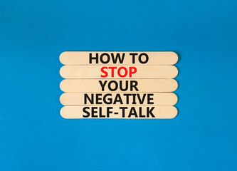 Stop negative self-talk symbol. Concept words How to stop your negative self-talk on wooden stick. Beautiful blue table blue background. Psychological negative self-talk concept. Copy space