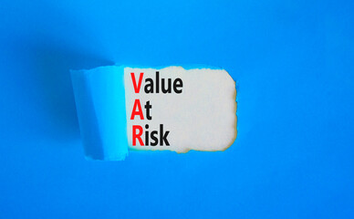 VAR Value at risk symbol. Concept words VAR Value at risk on beautiful white paper. Beautiful blue table blue background. Business and VAR Value at risk concept. Copy space.