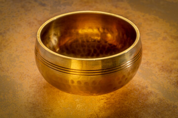 tibetan singing bowl on a backlit leather surface, sound therapy for healing, relaxation and...