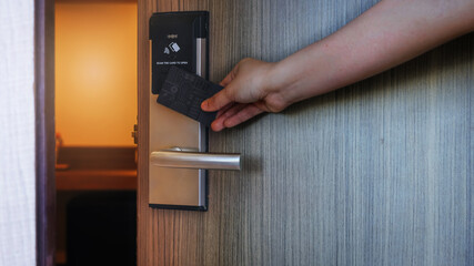 Smart card door key lock system in hotel. Hotel electronic lock on wooden door. Entrance door with electronic card lock security. Digital door lock security systems for access protection of hotel