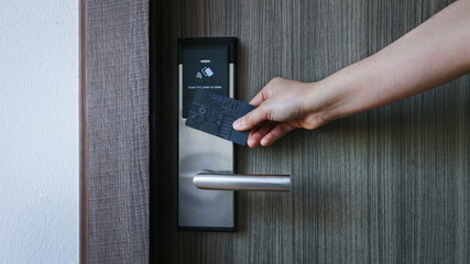 Smart card door key lock system in hotel. Hotel electronic lock on wooden door. Entrance door with...