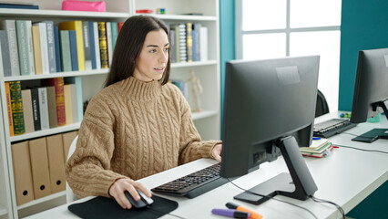 Young beautiful hispanic woman student using computer smiling at university classroom