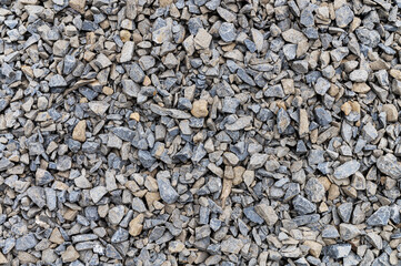 Crushed stone as a background. Grey granite gravel background for mix concrete. Construction rock.