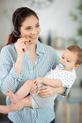 busy businesswoman working with baby on lap