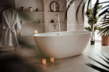 Naklejka na ściany i meble Luxury interior of big bathroom at modern african style with oval bathtub in natural lighting
