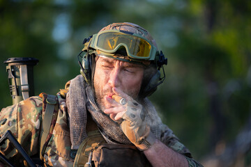 Portrait of a smoking mercenary soldier.