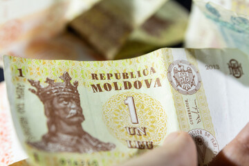 CHISINAU, MOLDOVA - MARCH 1, 2023: Selective blur on banknotes of 1 moldovan leu. The leu, or lei, it is the official currency of the republic of Moldova.