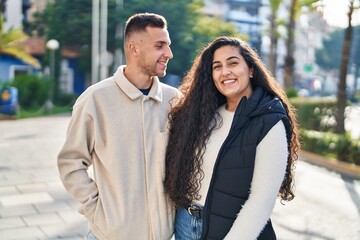 Man and woman couple smiling confident standing together at park