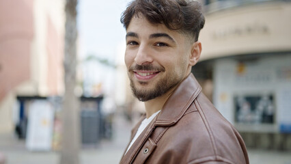 Young arab man smiling confident standing at street