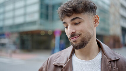 Young arab man smiling confident standing at street
