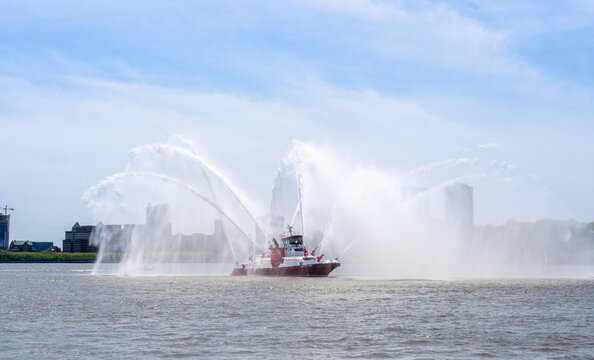 New York, United States - May 7, 2023: FDNY Fireboat pumping water creating a powerful spray on the Hudson River.
