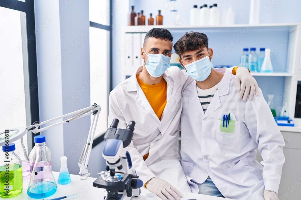 Wall mural Two man scientists wearing medical mask at laboratory