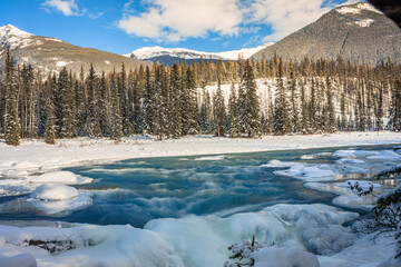 Waterfalls covered in snow and ice at sunset