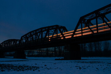 Covered train bridge over a frozen river